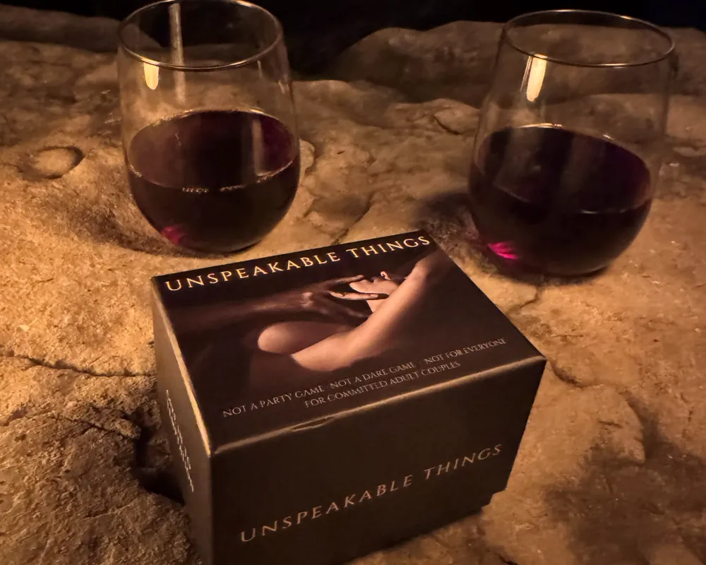 The box on stone beside two glasses of red wine